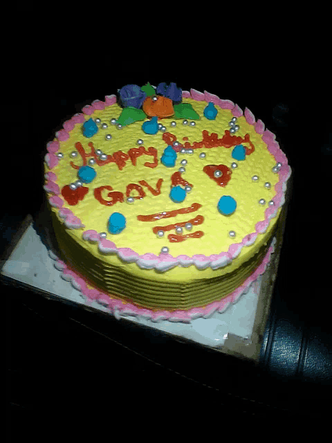 a yellow cake with pink frosting and the words happy birthday gav on it