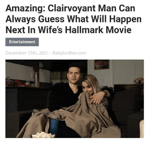 a man and a woman are sitting on a couch watching a hallmark movie with popcorn