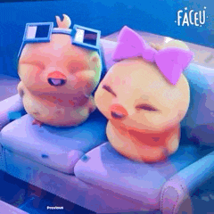two stuffed chickens are sitting on a couch wearing sunglasses and bows .