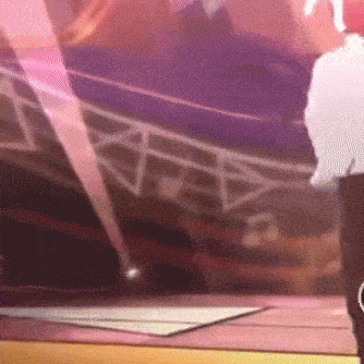 a person is standing on a stage in front of a purple background .