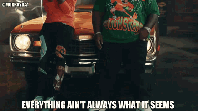 two men standing in front of an orange car with the words everything ain t always what it seems
