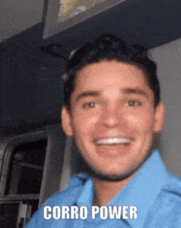 a man in a blue shirt is smiling with the words corro power written below him