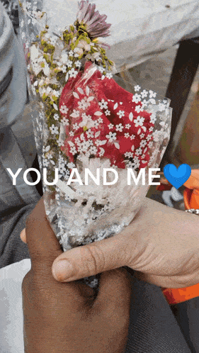 a person holding a bouquet of flowers with the words " you and me " above them