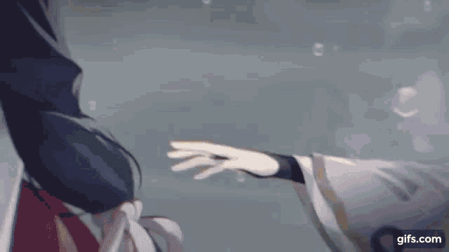 a person is holding another person 's hand in the air .