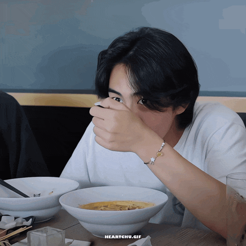 a gif of a person eating a bowl of soup with the words heartchu.gif below it