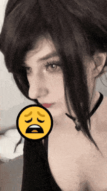 a close up of a woman 's face with a yellow smiley face in the corner