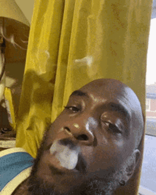 a man with a beard is smoking a cigarette