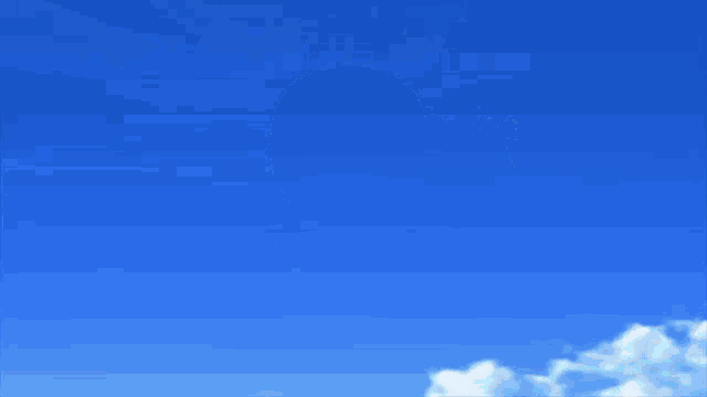 a yellow balloon is flying in the blue sky