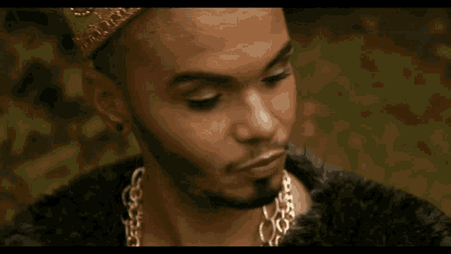 a man wearing a fur coat and gold chains