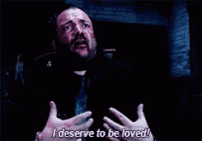 a man is saying i deserve to be loved in a dark room .