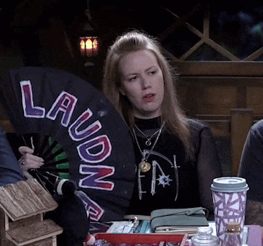 a woman holds a fan that says laudon on it