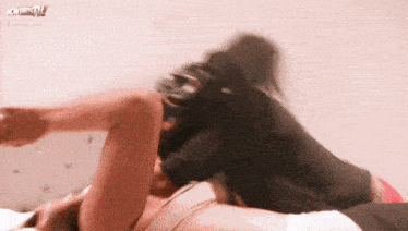 a woman is laying on a bed with the word wow on the bottom