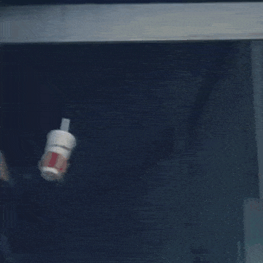 a person walking up a set of metal stairs in a dark hallway