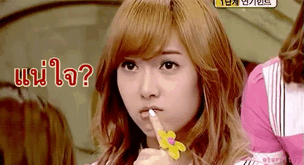 a girl with a flower ring on her finger is making a shhh gesture with her finger