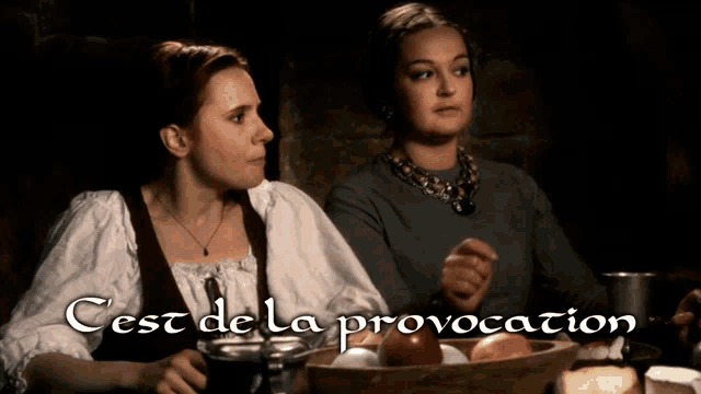 two women sitting at a table with the words cest de la provocation written on the bottom