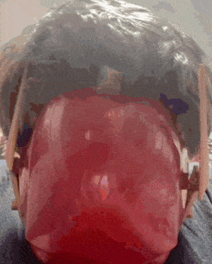a close up of a person wearing headphones with a red light behind them