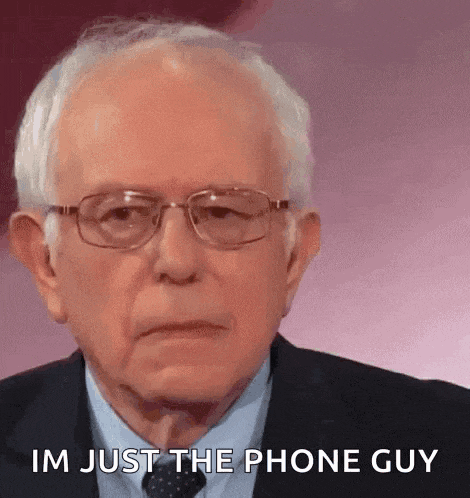 a man in a suit and tie is saying i 'm just the phone guy