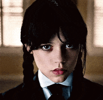 a close up of a girl wearing a suit and tie with pigtails