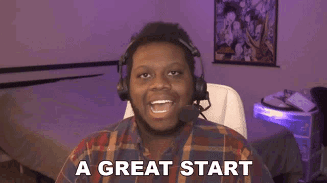 a man wearing headphones says a great start in front of a microphone .