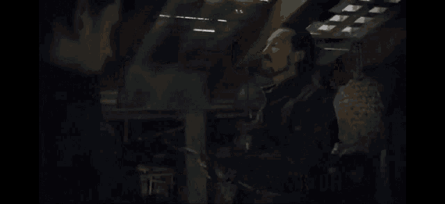 a man sitting in a dark room with the words " you are " on the bottom
