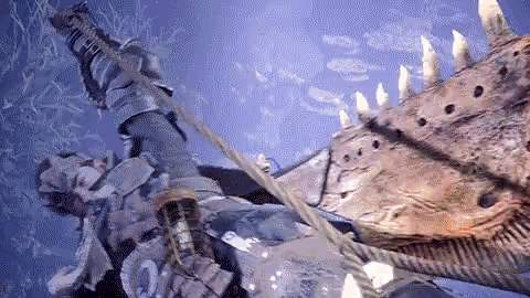 a man is hanging from a rope next to a large monster .