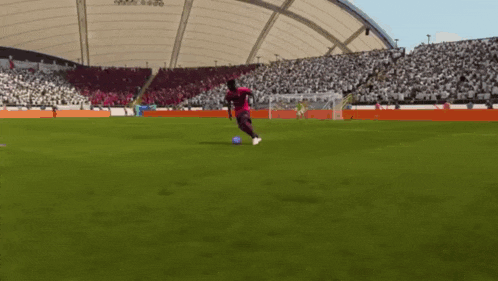 a soccer player is kicking a soccer ball on a field with a crowd watching