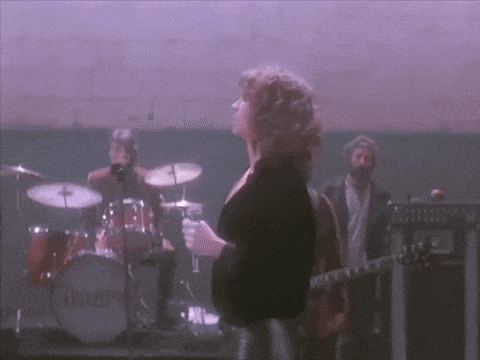 a woman stands in front of a drum set that says ' ibanez ' on it