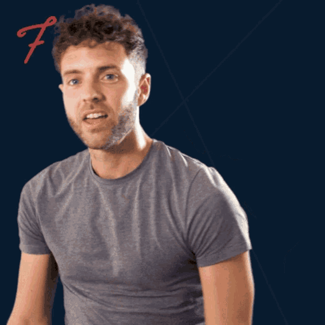 a man giving a thumbs up with a letter f behind him