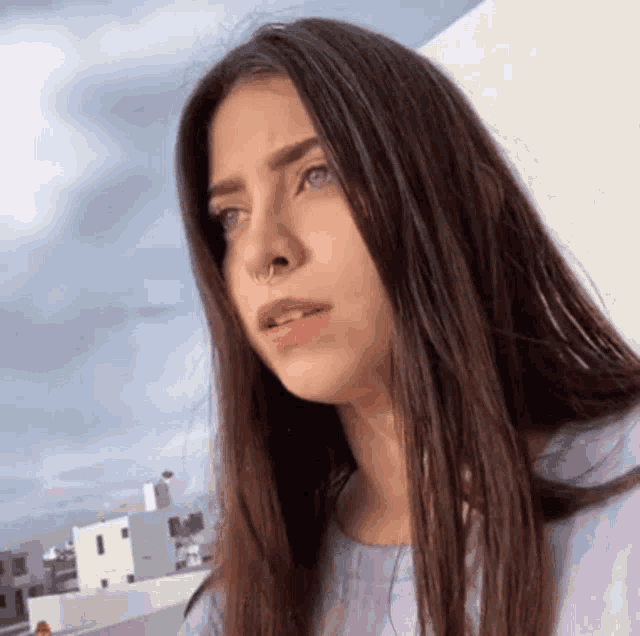 a woman with long hair and a nose ring