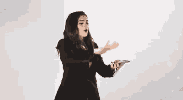 a woman in a suit is throwing money in the air and screaming