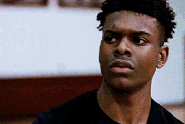 a close up of a young man 's face with a serious expression