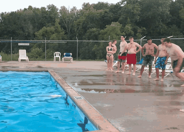 a swimming pool with a no diving sign on the side