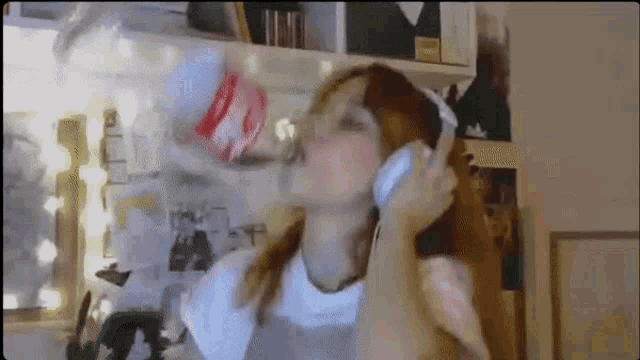 a woman is drinking from a coca cola bottle