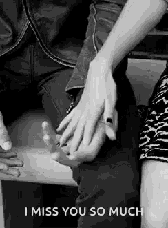 a black and white photo of a man and woman holding hands with the words `` i miss you so much '' .