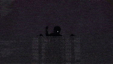 a silhouette of a person standing in front of a screen with white dots coming out of it