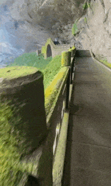 a road going through a tunnel with a bridge going through it