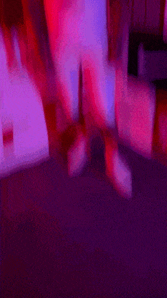 a blurry picture of a person in a pink shirt