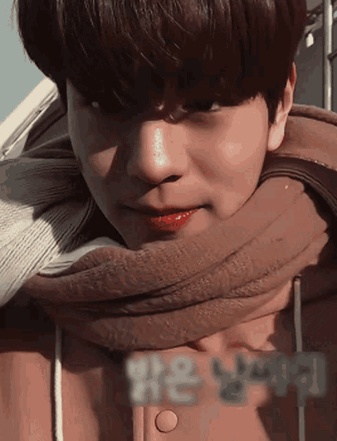 a close up of a person wearing a scarf and a jacket