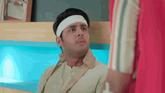 a man with a bandage on his head is sitting in a chair