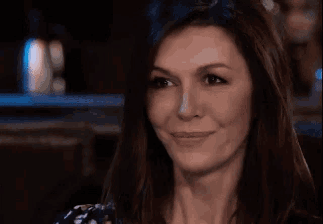a close up of a woman 's face with a slight smile on her face .