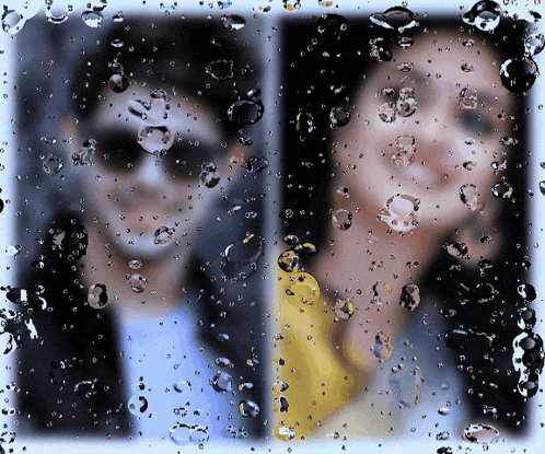 a picture of a man and a woman behind a window with water drops