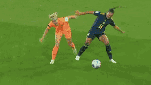 a soccer game is being played on a field with a few advertisements on the side