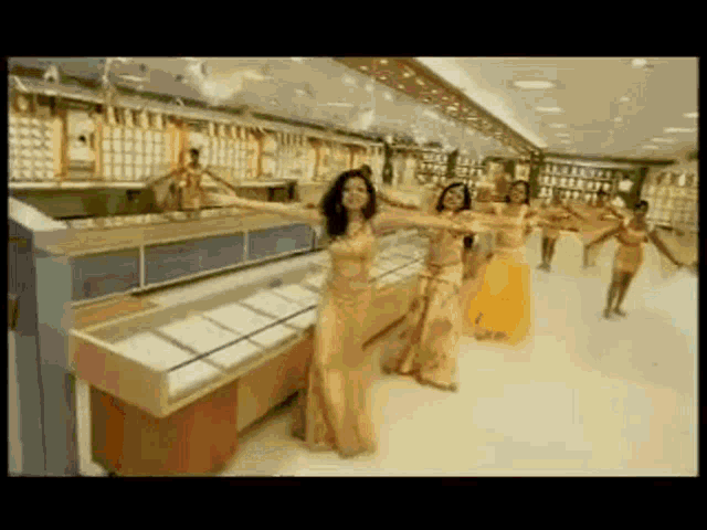 a group of belly dancers are dancing inside of a store