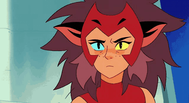 a close up of a cartoon character wearing a red mask with yellow eyes