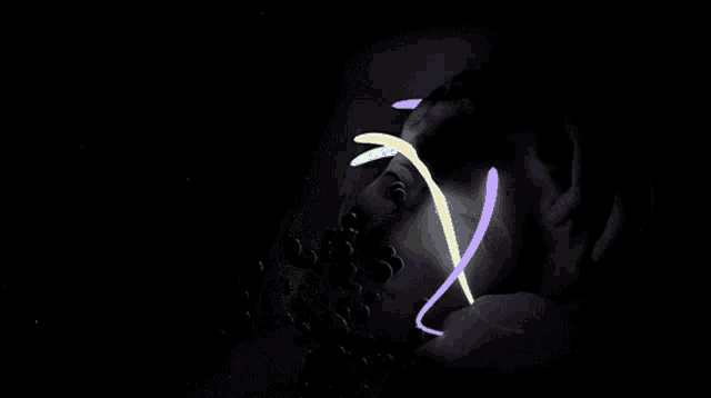 a purple and yellow swirl is surrounded by red hearts on a black background
