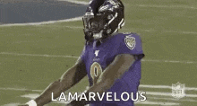 a football player in a purple uniform is standing on a field with the words `` lamarvelous '' written above him .