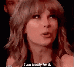 a close up of a woman 's face with the words `` i am thirsty for it '' written on her face .