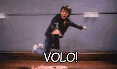 a man in a leather jacket is jumping in the air with the word volo in front of him