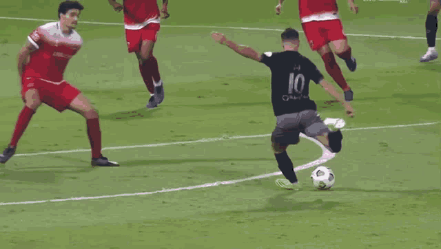 a blurry picture of a soccer player on a field with a ball in the air