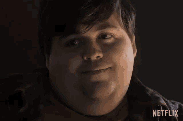 a close up of a man 's face with a netflix logo behind him